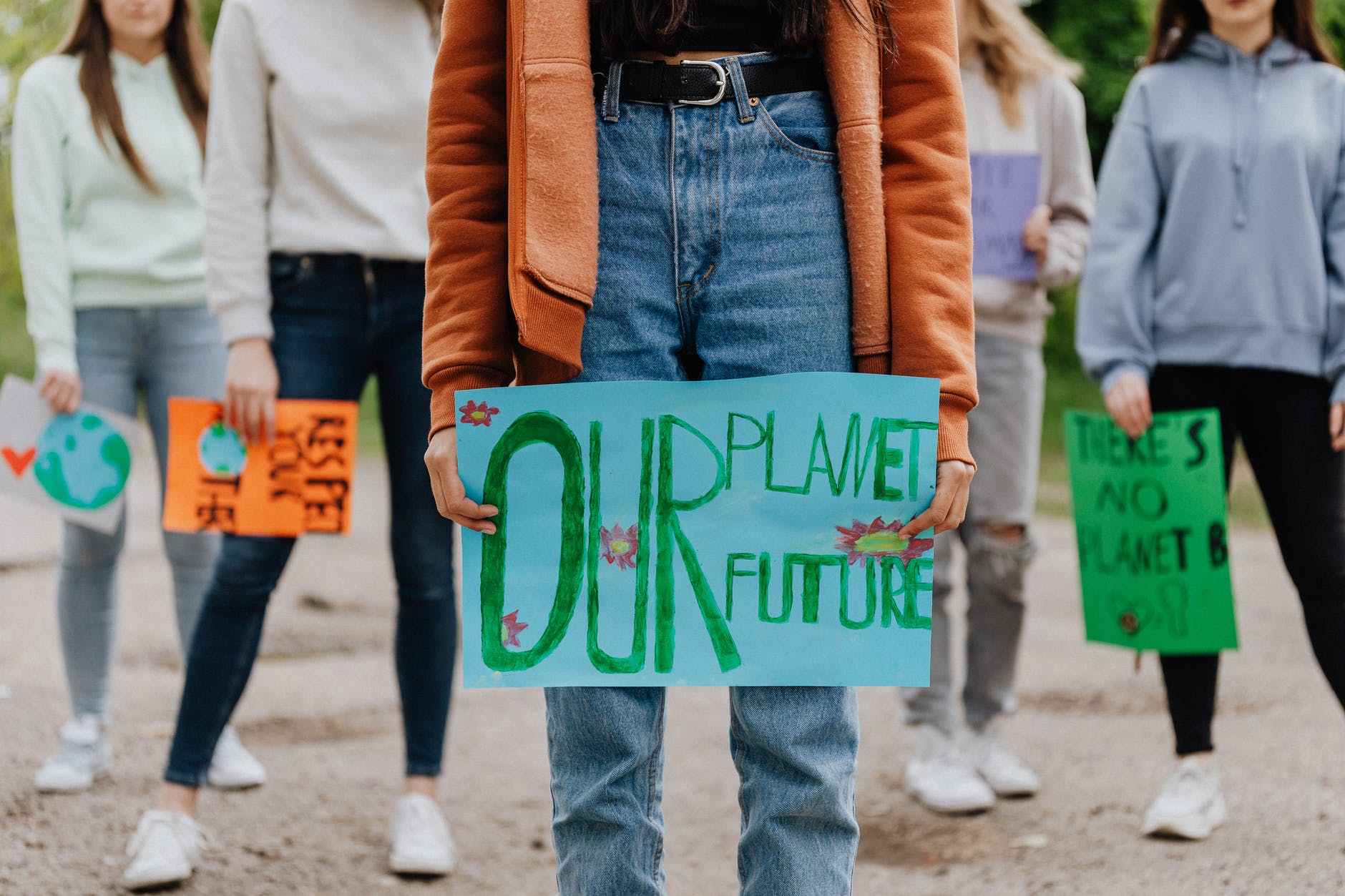 picture of climate activists holding signs